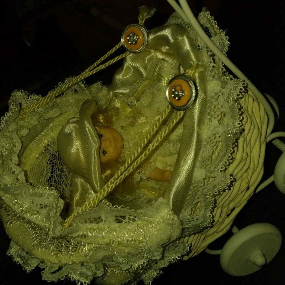 Vintage porcelain doll in stroller